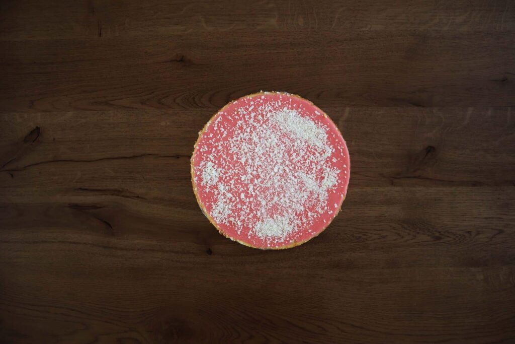 Een roze traktatie met witte suiker erover.